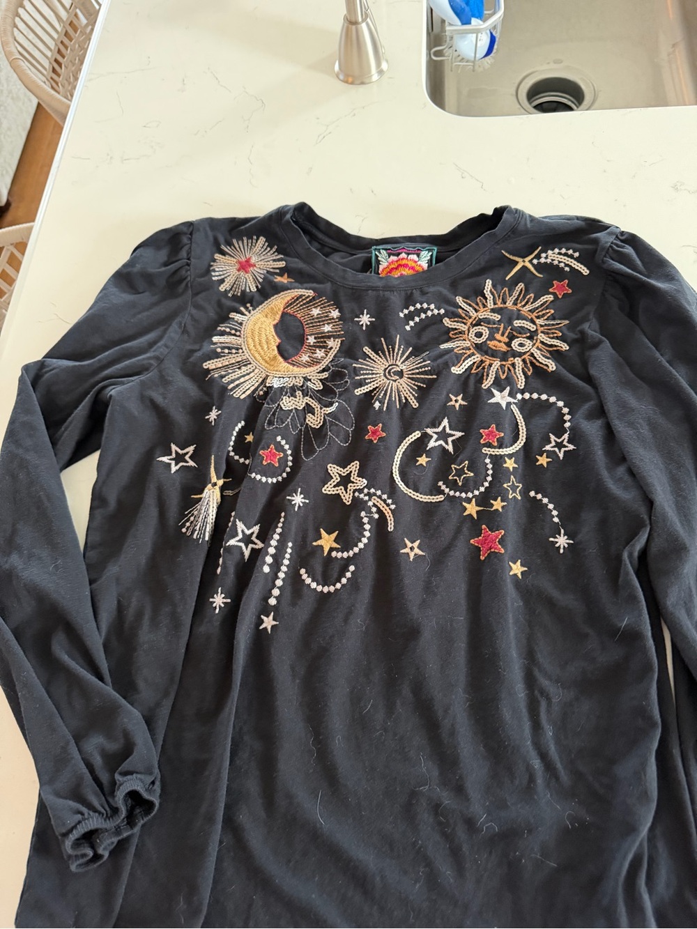 Women’s Johnny Was Black Long-Sleeve Top with Sun & Moon Embroidery.
